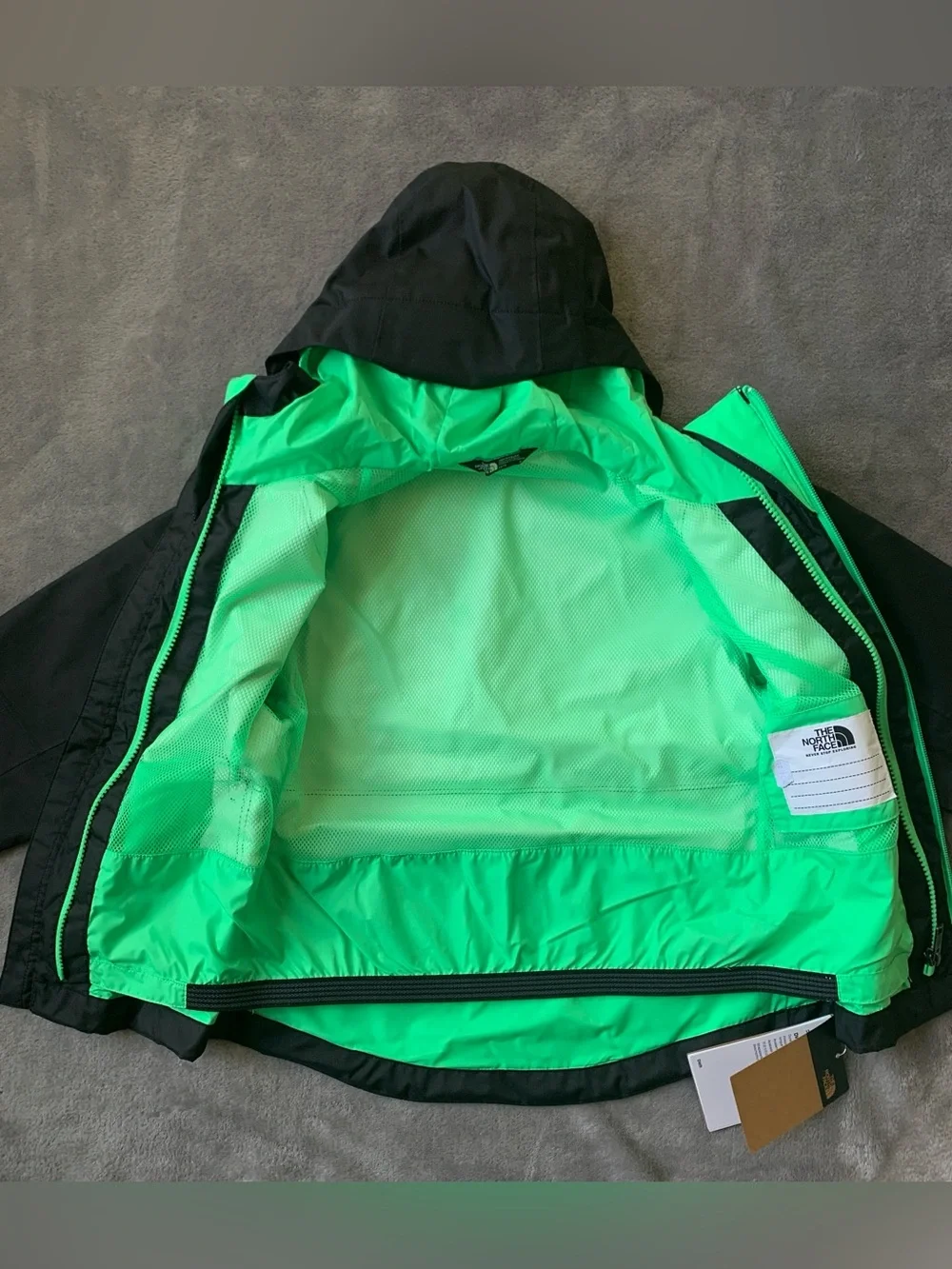 The North Face Black Hooded Jacket with Green Lining & Pink Zippers